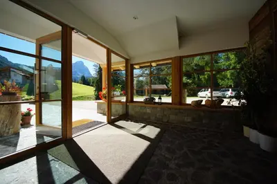 a room with large windows and a view of a mountain at Chalet Frapes in San Martino in Badia