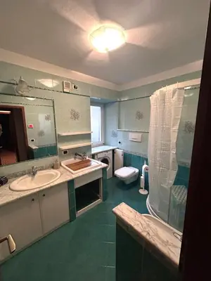 a bathroom with two sinks and a toilet and a mirror at Casa Checolongo by Sunhome Fiemme in Ziano di Fiemme