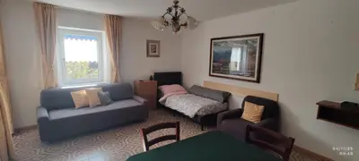 a living room with a couch and a table at Casa Checolongo by Sunhome Fiemme in Ziano di Fiemme