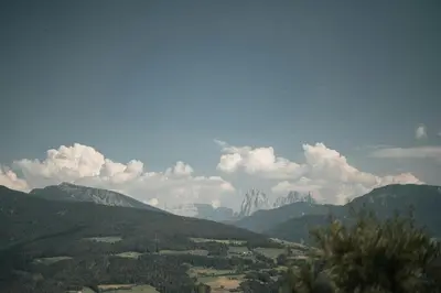 a view of a mountain range with clouds in the sky at Historic Alpine Lodge In The Heart Of South Tyrol in Villandro