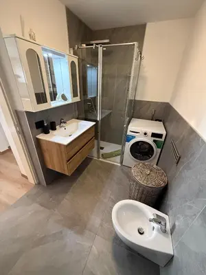 a bathroom with a sink and a shower and a toilet at Appartamento Moena in Moena
