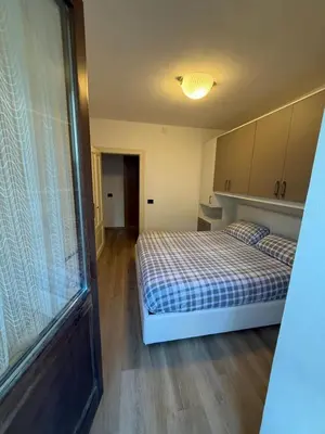 a bedroom with two beds and a window at Appartamento Moena in Moena