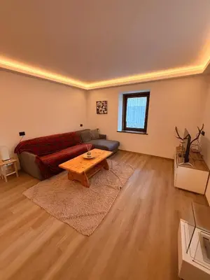 a living room with a couch and a coffee table at Appartamento Moena in Moena