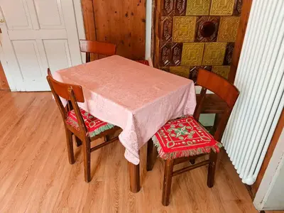 a table with two chairs and a table with a pink table cloth at Casa Bruna by Go New Location in Varena