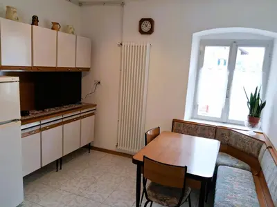 a living room with a table and a kitchen at Casa Bruna by Go New Location in Varena