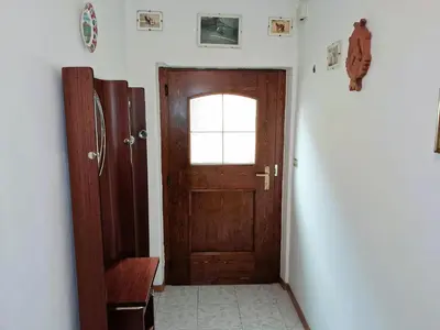 a hallway with a wooden door and a window at Casa Bruna by Go New Location in Varena