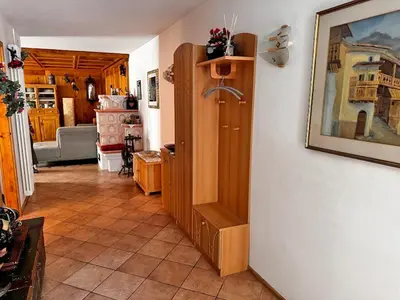 a bathroom with a washing machine and a toilet at Appartamento Town Center in Predazzo