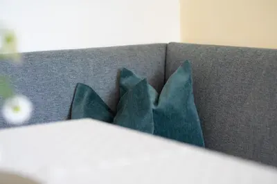 a group of four blue pillows on a couch at Appartement Huber in Merano
