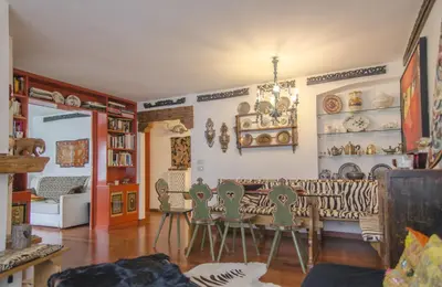 a room with a table and chairs in it at Casa Cristallo in Cortina dʼAmpezzo