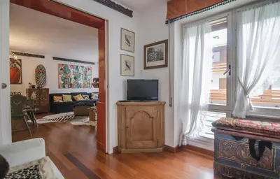 a living room with a tv on a wooden stand at Casa Cristallo in Cortina dʼAmpezzo