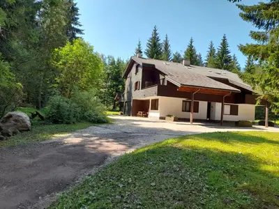 a house with a gravel driveway in front of it at Appartamento Magico Abete by Sunhome Fiemme in Bellamonte