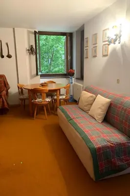 a living room with a couch and a table at Appartamento Magico Abete by Sunhome Fiemme in Bellamonte