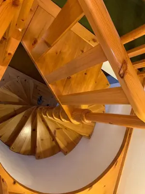 an overhead view of a wooden spiral staircase at Appartamento Magico Abete by Sunhome Fiemme in Bellamonte
