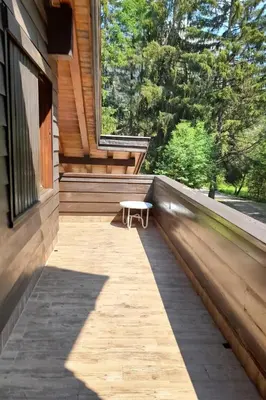 a bench sitting on the porch of a house at Appartamento Magico Abete by Sunhome Fiemme in Bellamonte