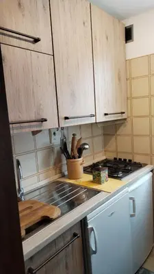 a kitchen with wooden cabinets and a stove top oven at Via Latemar - Villaggio Veronza in Carano