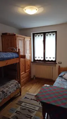 a bedroom with two bunk beds and a window at Via Latemar - Villaggio Veronza in Carano