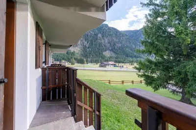 a balcony of a house with a view of a field at Cesa Agnol in Mazzin