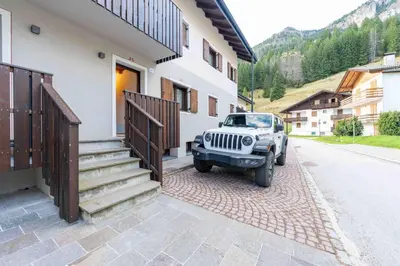 a jeep parked in front of a house at Cesa Agnol in Mazzin