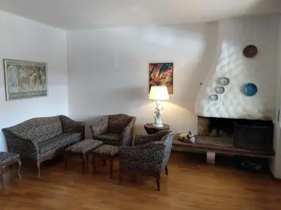 a living room with chairs and a fireplace at Appartamento in chalet ampezzano in Alvera