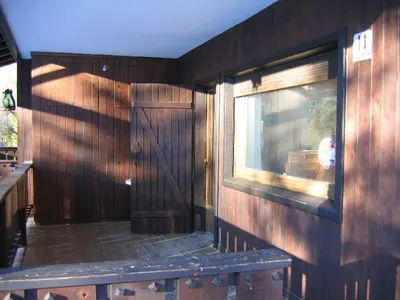 a wooden room with a door and a window at Appartamento in chalet ampezzano in Alvera