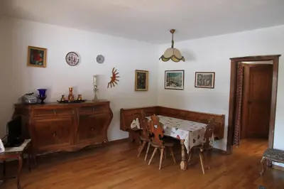 a dining room with a table and chairs at Appartamento in chalet ampezzano in Alvera