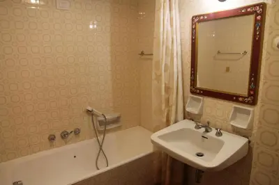 a bathroom with a sink and a tub and a mirror at Appartamento in chalet ampezzano in Alvera