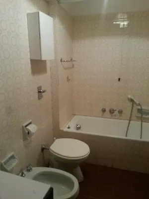 a bathroom with a toilet and a bath tub at Appartamento in chalet ampezzano in Alvera