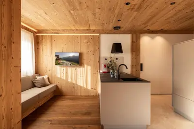 a kitchen with a couch and a table in a room at Dickerhof - Urlaub auf dem Bauernhof in San Genesio Atesino