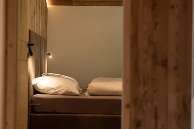 a bedroom with two beds with white pillows at Dickerhof - Urlaub auf dem Bauernhof in San Genesio Atesino