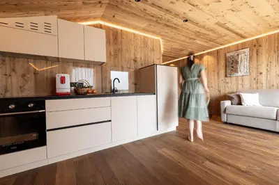 a woman standing in the kitchen of a house at Dickerhof - Urlaub auf dem Bauernhof in San Genesio Atesino