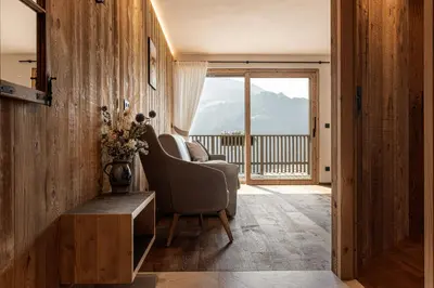 a living room with a couch and a chair at Dickerhof - Urlaub auf dem Bauernhof in San Genesio Atesino