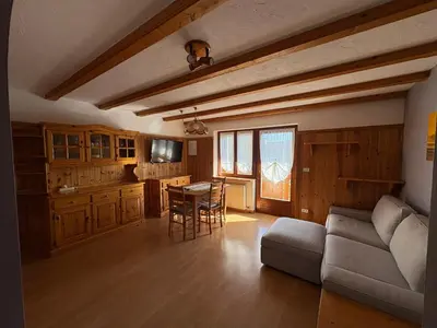 a living room with a couch and a table at Casa Girasole in Carano