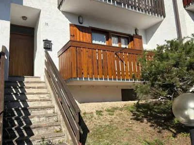 a house with a wooden balcony with a window at Casa Girasole in Carano