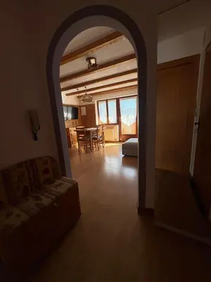 a living room with a couch and a dining room at Casa Girasole in Carano