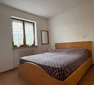 a bedroom with a bed and a window at Casa Girasole in Carano