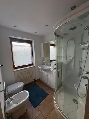 a bathroom with a shower and a toilet and a sink at Casa Girasole in Carano