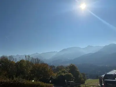a view of a mountain with the sun in the sky at Casa Girasole in Carano