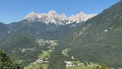 a view of a mountain range with a town in a valley at Caluma El Paradis in Comune Rivamonte Agordino