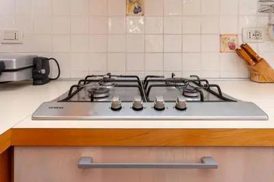 a stove top oven sitting on top of a kitchen counter at Casa Sangi in Caviola