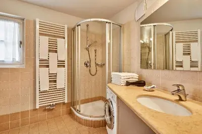 a bathroom with a sink and a shower at Residence Amonit in Corvara in Badia