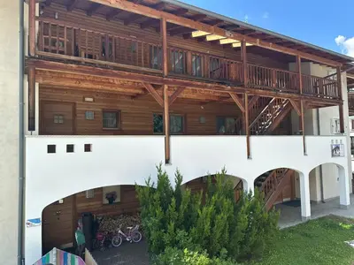 an apartment building with a balcony and bikes in the courtyard at Residence Amonit in Corvara in Badia