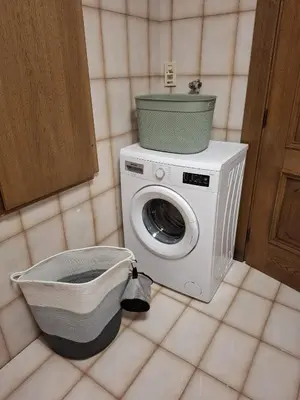 a washing machine with a bucket on top of it at Appartamenti - Sass de Stria Cernadoi Dolomiti in Andraz