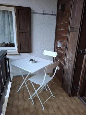 a white table and a chair in a kitchen at Appartamenti - Sass de Stria Cernadoi Dolomiti in Andraz
