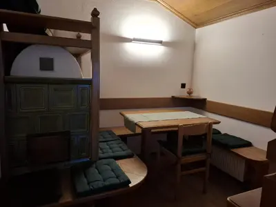 a room with a table and a bunk bed at Appartamenti - Sass de Stria Cernadoi Dolomiti in Andraz