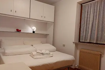 a bedroom with a bed with towels on it at Two-bedroom apartment-Casa Pieri in Penia