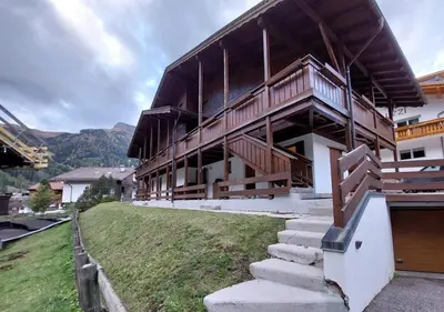 a large building with stairs in front of it at Two-bedroom apartment-Casa Pieri in Penia