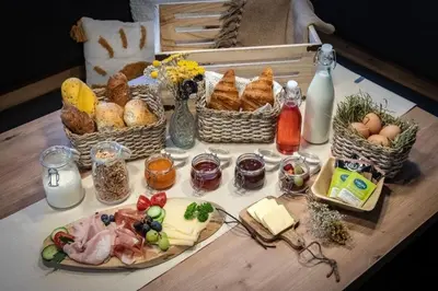 a table with baskets of food and eggs and bread at Niederhof - Urlaub auf dem Bauernhof in Brixen