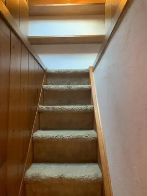 a staircase in a building with a stair case at Cortina central apartment overlooking Tofane Faloria in Cortina dʼAmpezzo
