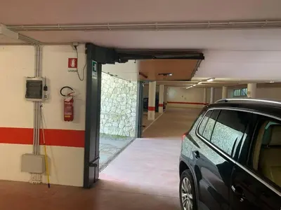 a parking garage with a car parked in it at Cortina central apartment overlooking Tofane Faloria in Cortina dʼAmpezzo