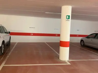 a parking garage with two cars parked in it at Cortina central apartment overlooking Tofane Faloria in Cortina dʼAmpezzo